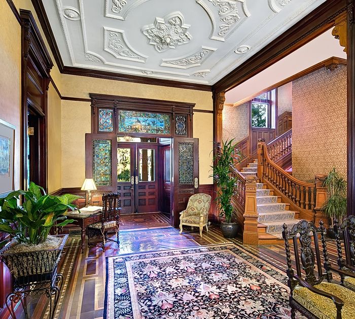 a room with a staircase and a rug