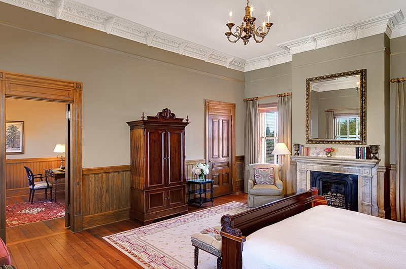 a bedroom with a fireplace and a bed