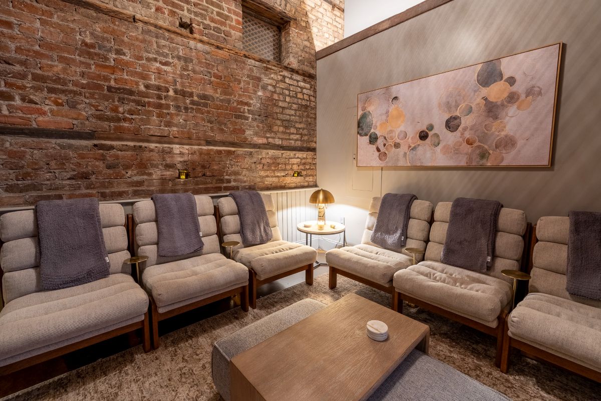 a room with a brick wall and chairs