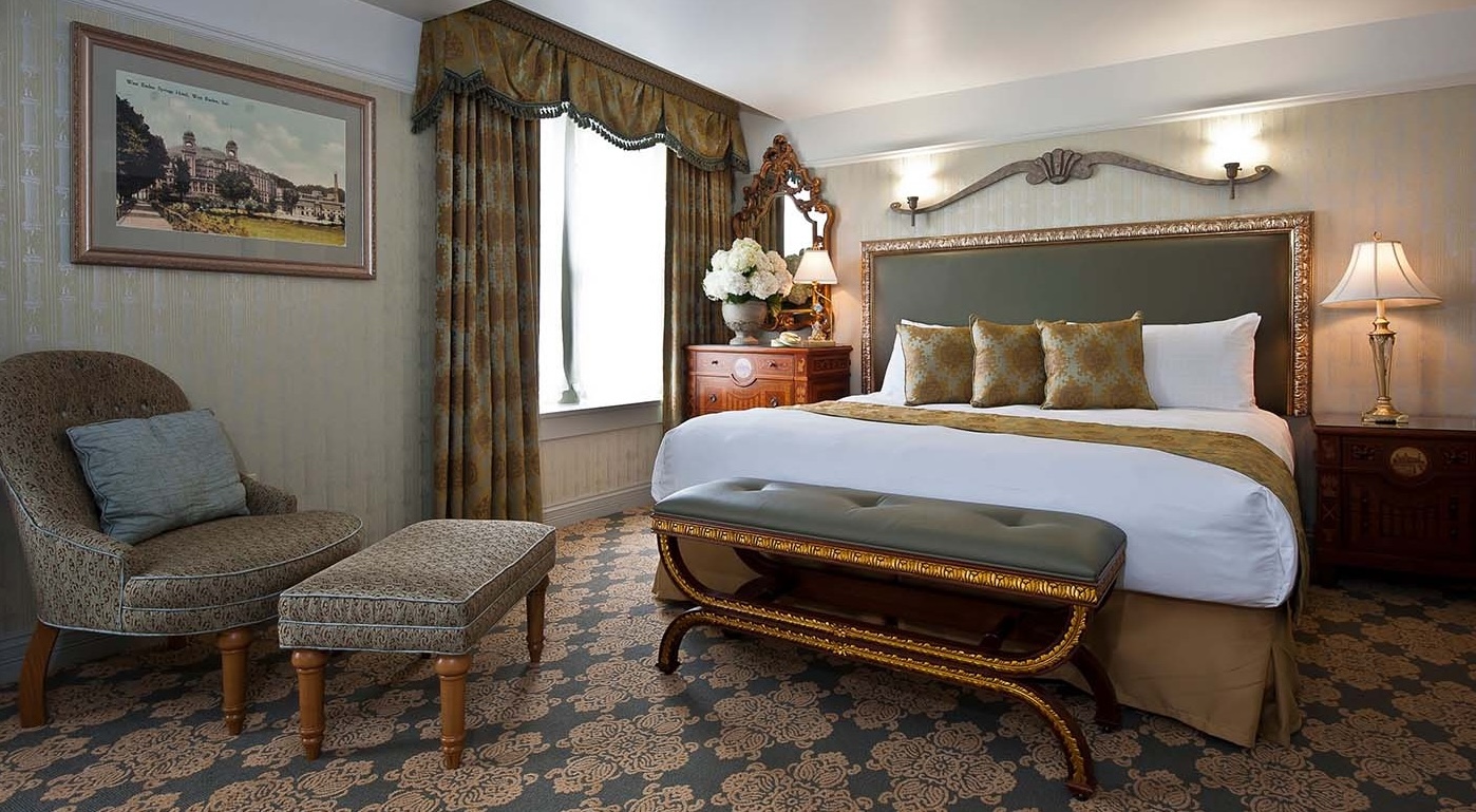 a bedroom with a bed and a bench