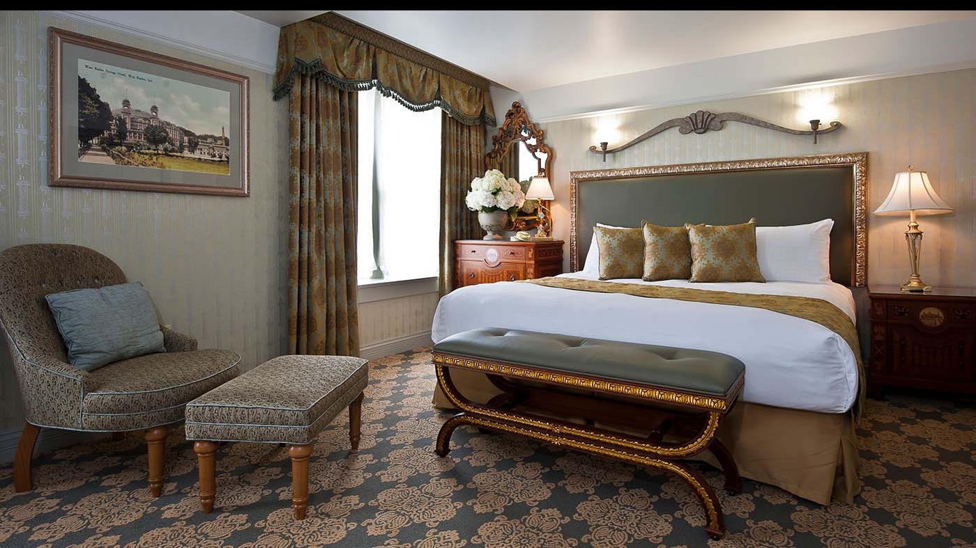 a bedroom with a bed and a bench