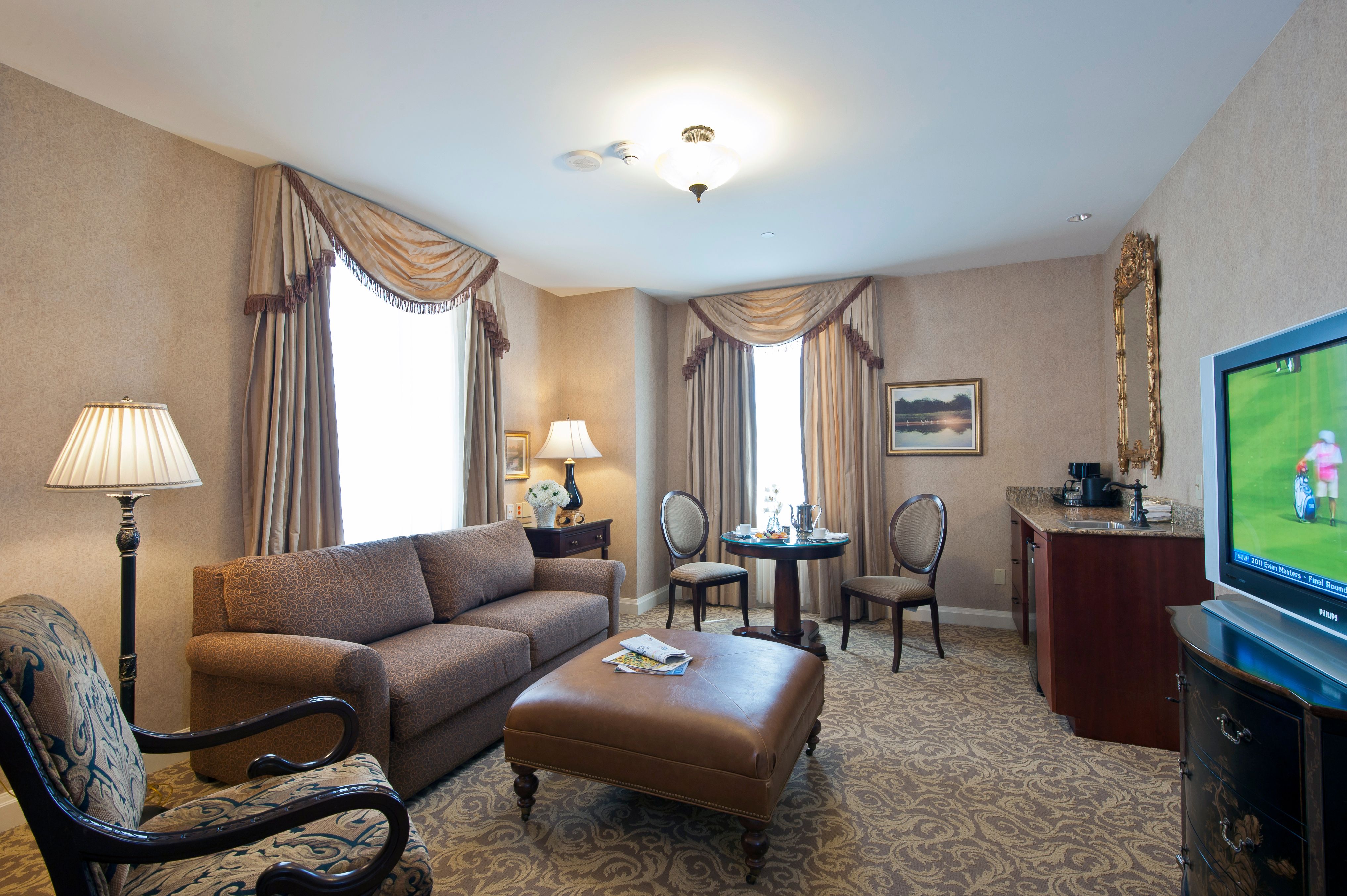 a room with a couch and chairs