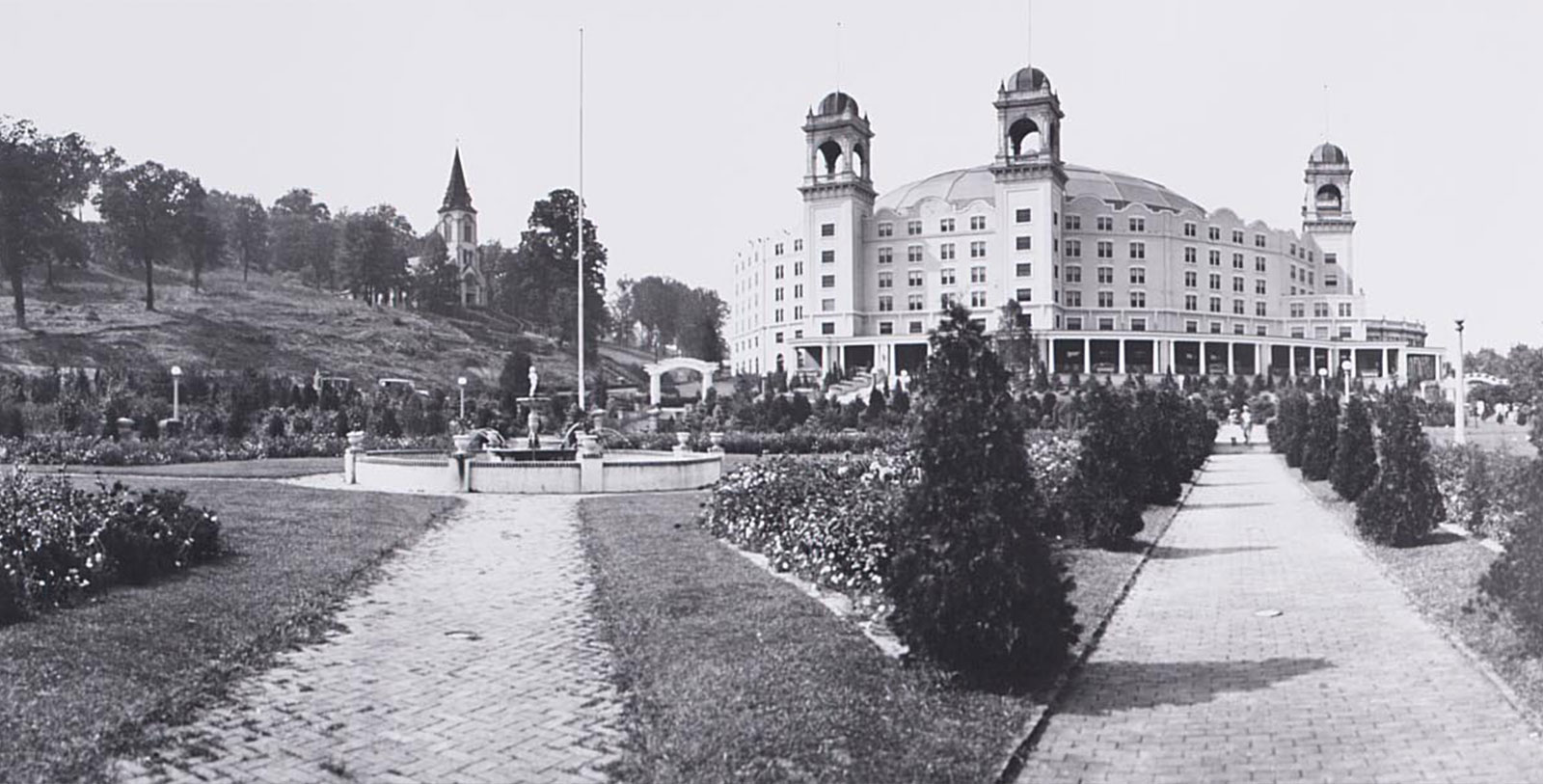 a large building with a fountain in front of it