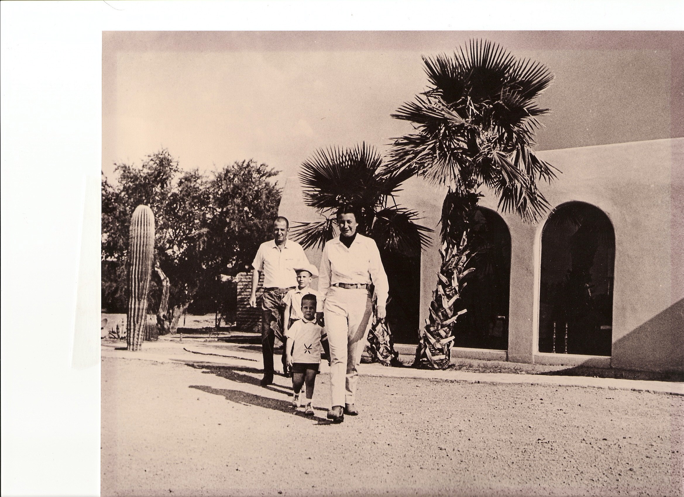 a group of men walking with two children