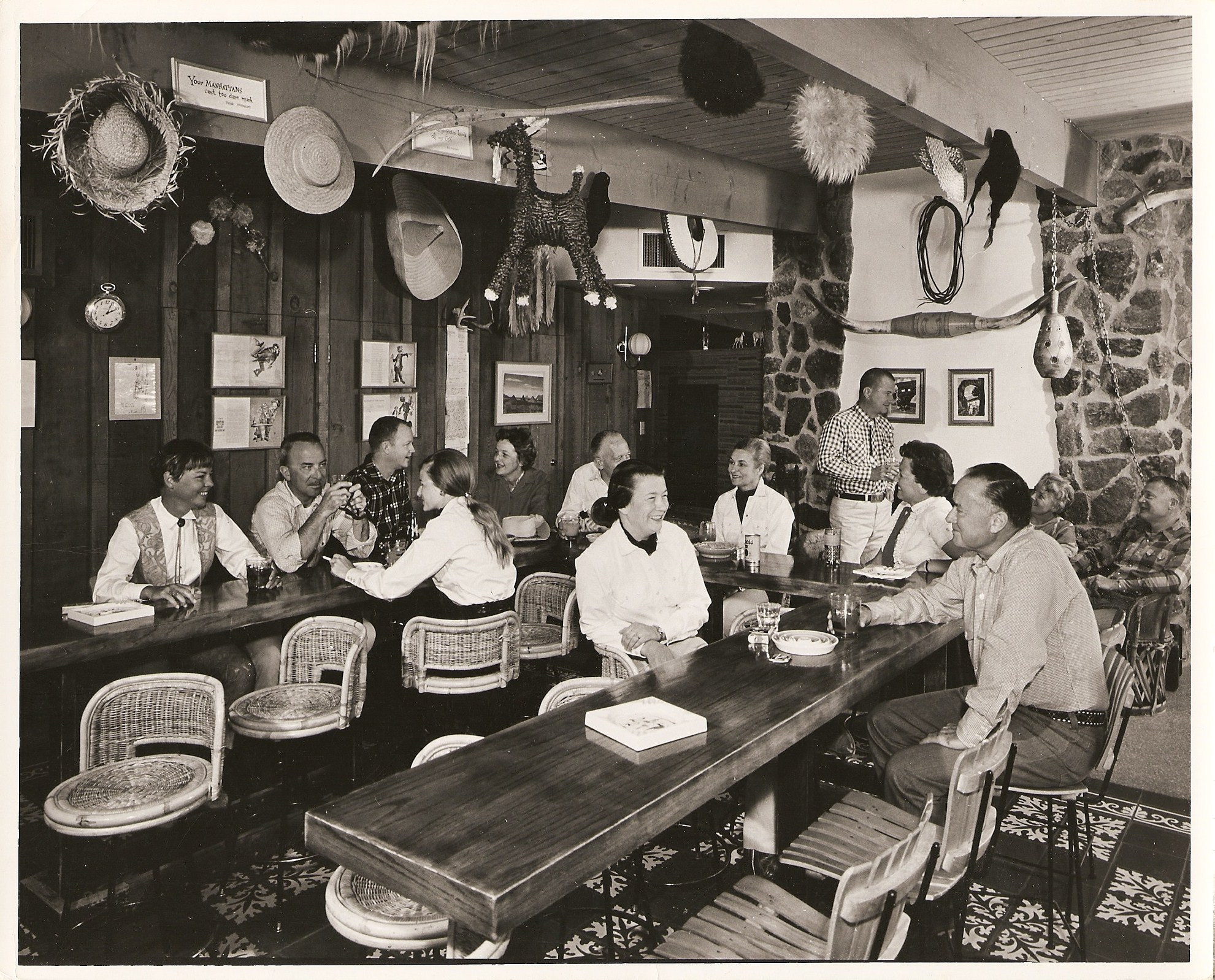 a group of people sitting at a long table