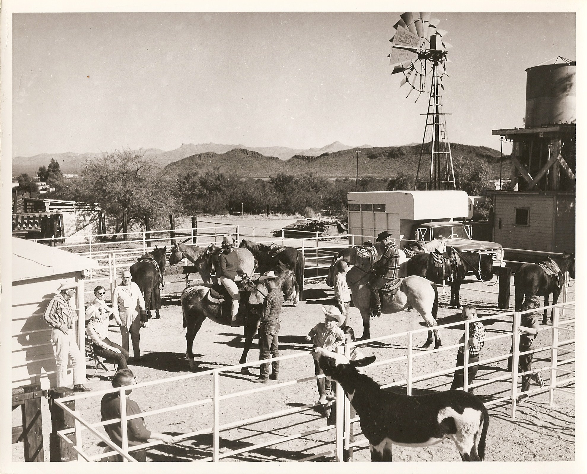 a group of people on horses and a windmill