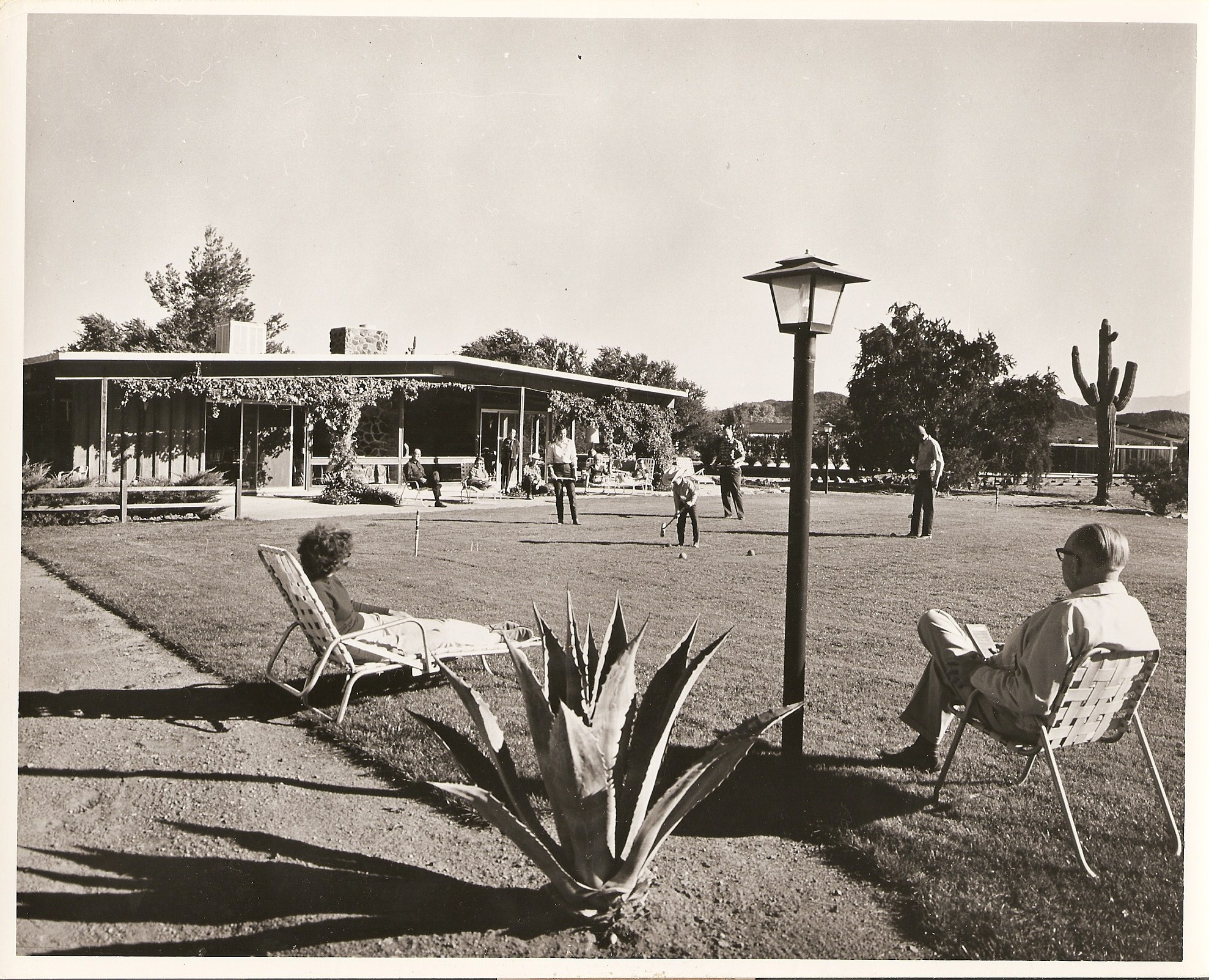 a group of people sitting in chairs outside a building