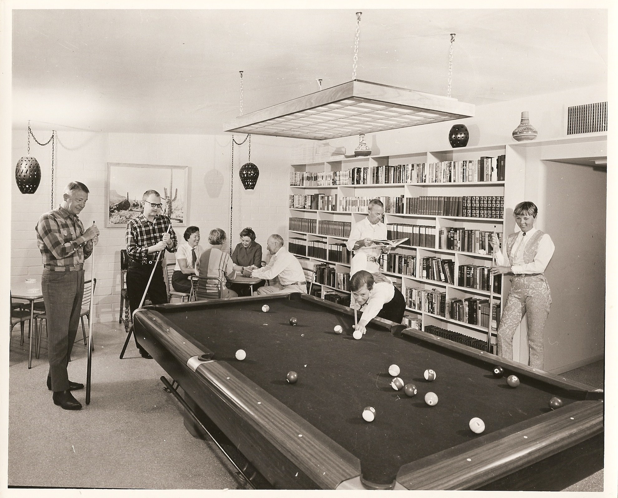 a group of people playing pool