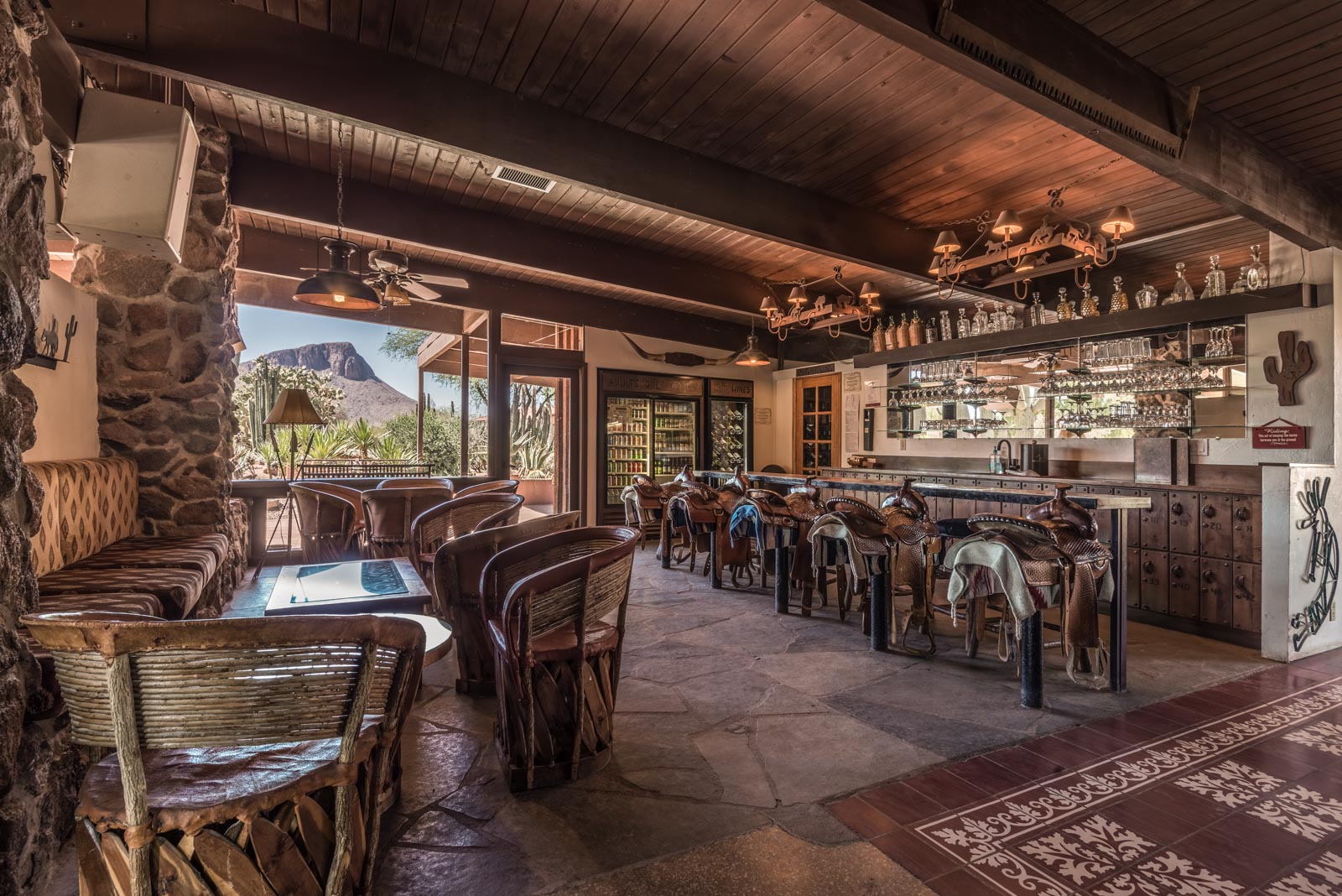 a room with a bar and chairs