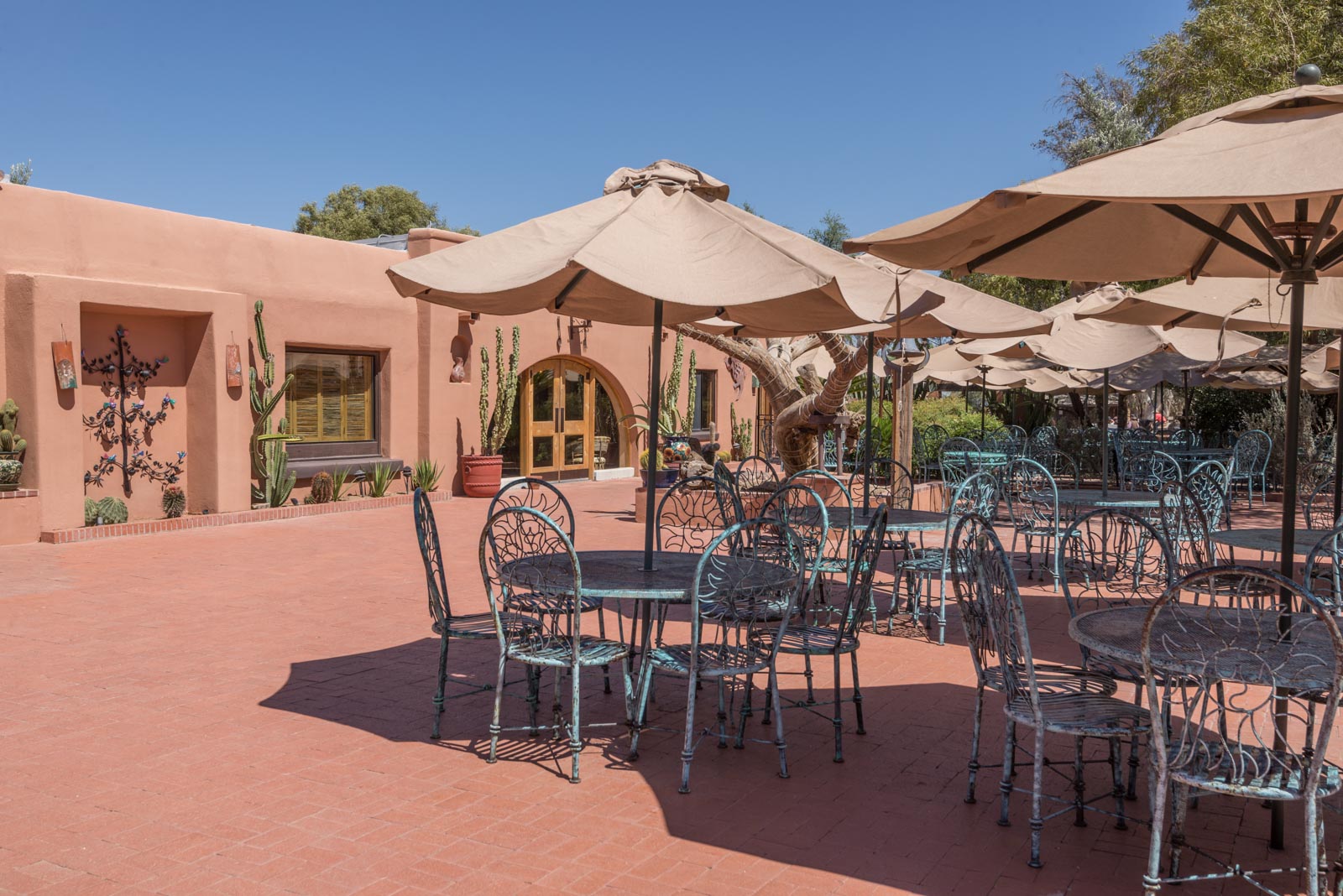 a patio with chairs and umbrellas