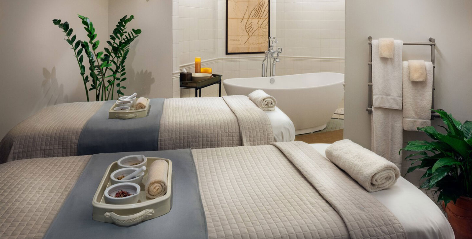 a room with two beds and a tub