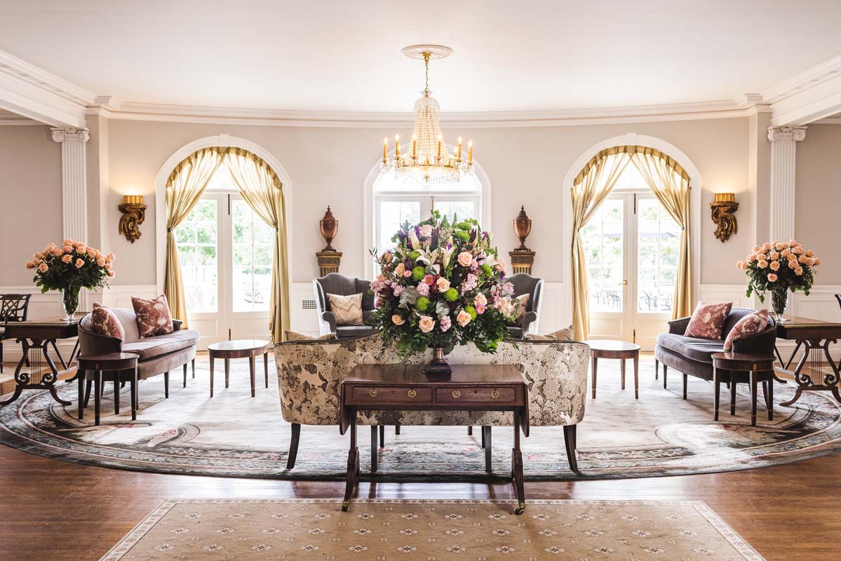 a room with a couch and a table with flowers
