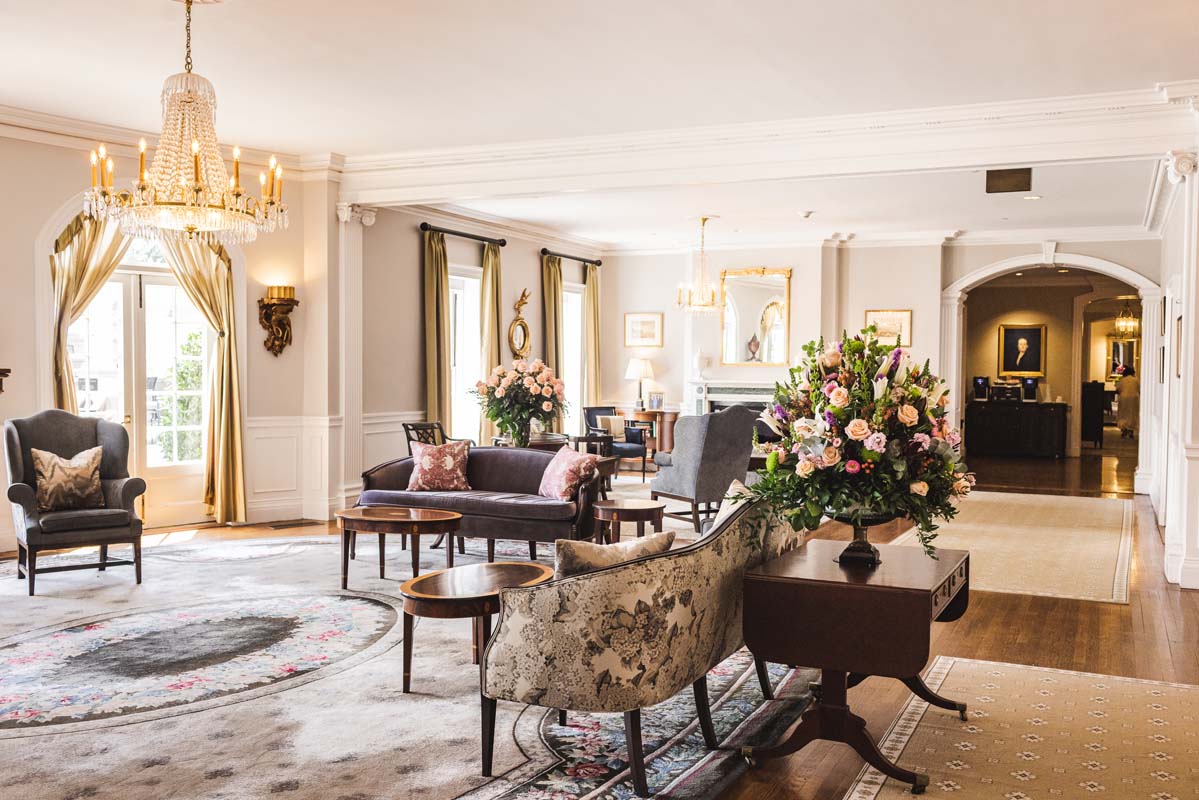 a room with a chandelier and couches