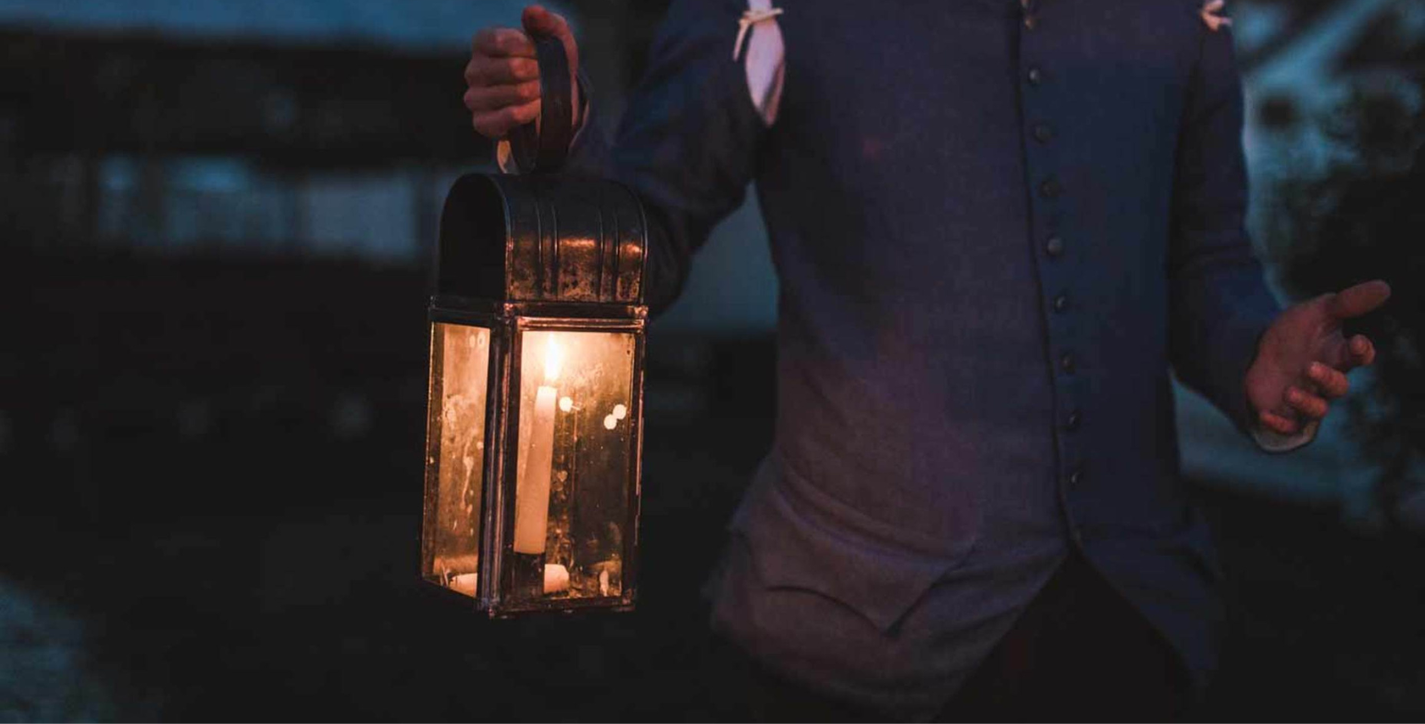 a person holding a lantern