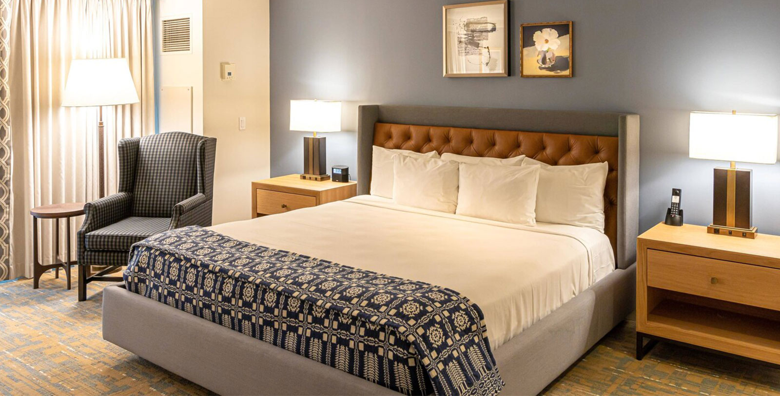 a bed with pillows and a lamp in a room