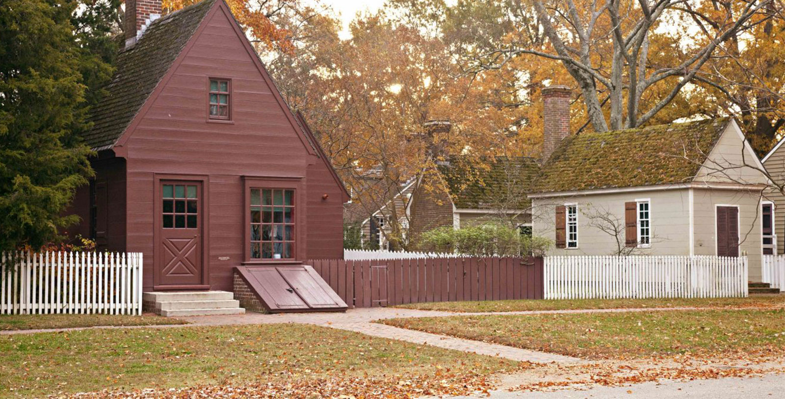a house with a fence and trees