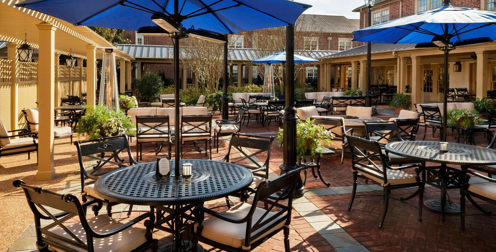 a patio with tables and chairs