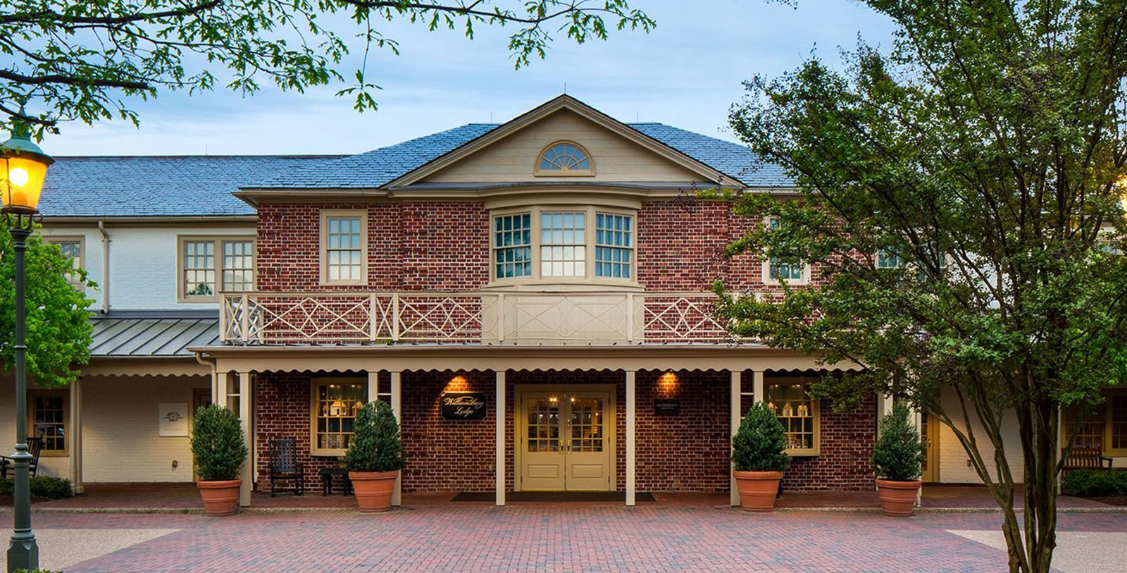 a brick building with trees in front