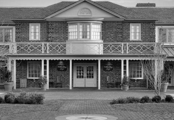 a brick building with a balcony, Williamsburg Lodge