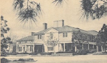 a large house with trees in the background