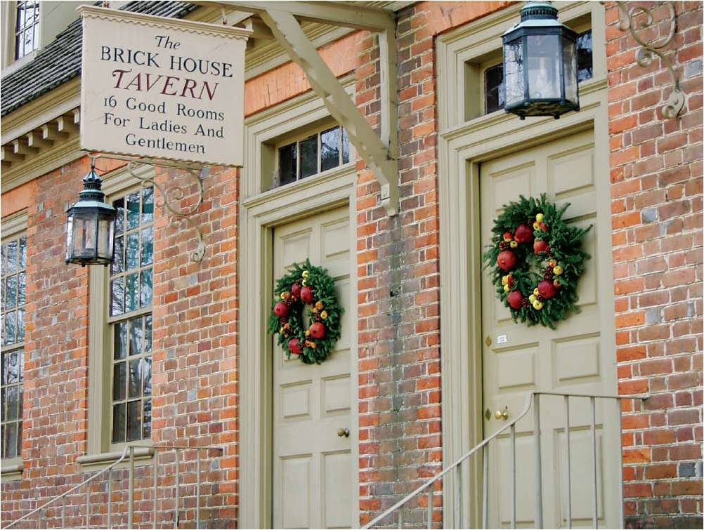 a brick building with a sign and wreaths