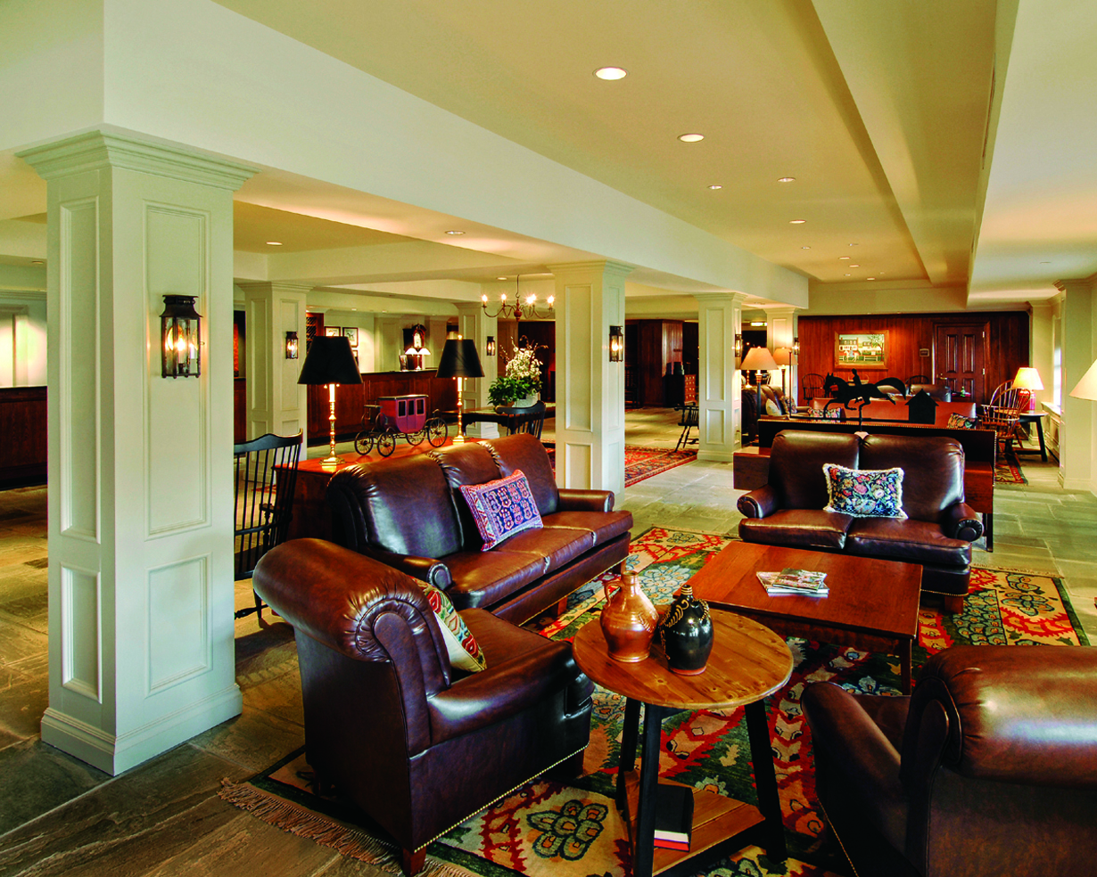 a room with leather couches and a table