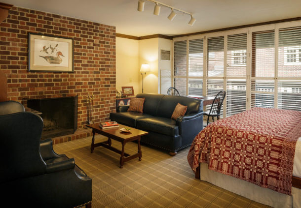 a room with a bed and a fireplace
