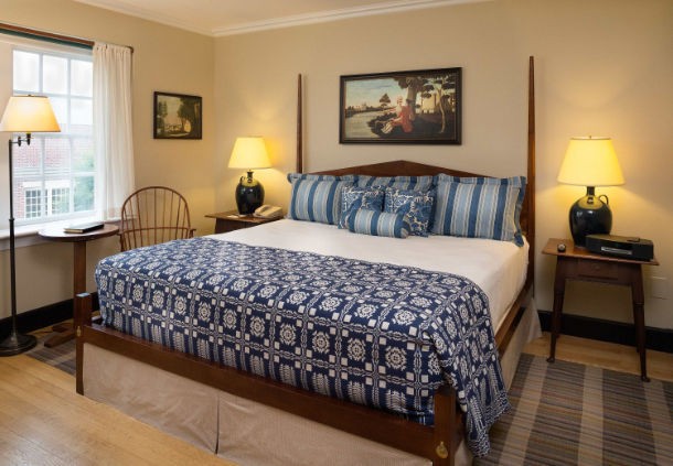 a bed with a blue and white cover