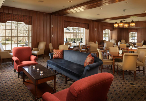 a room with a couch and chairs