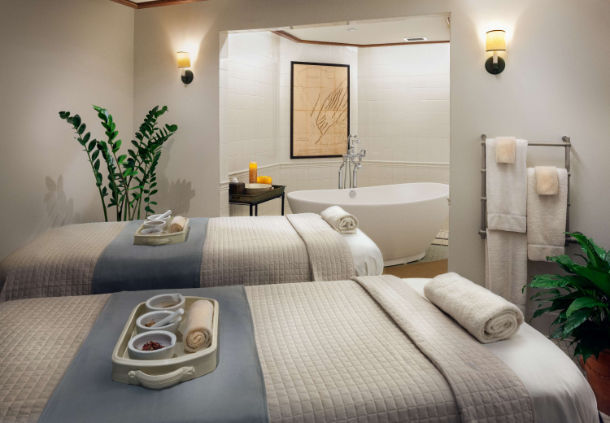 a room with two beds and a bathtub