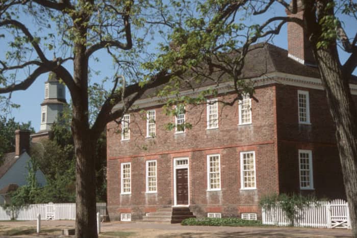 a brick building with a white fence