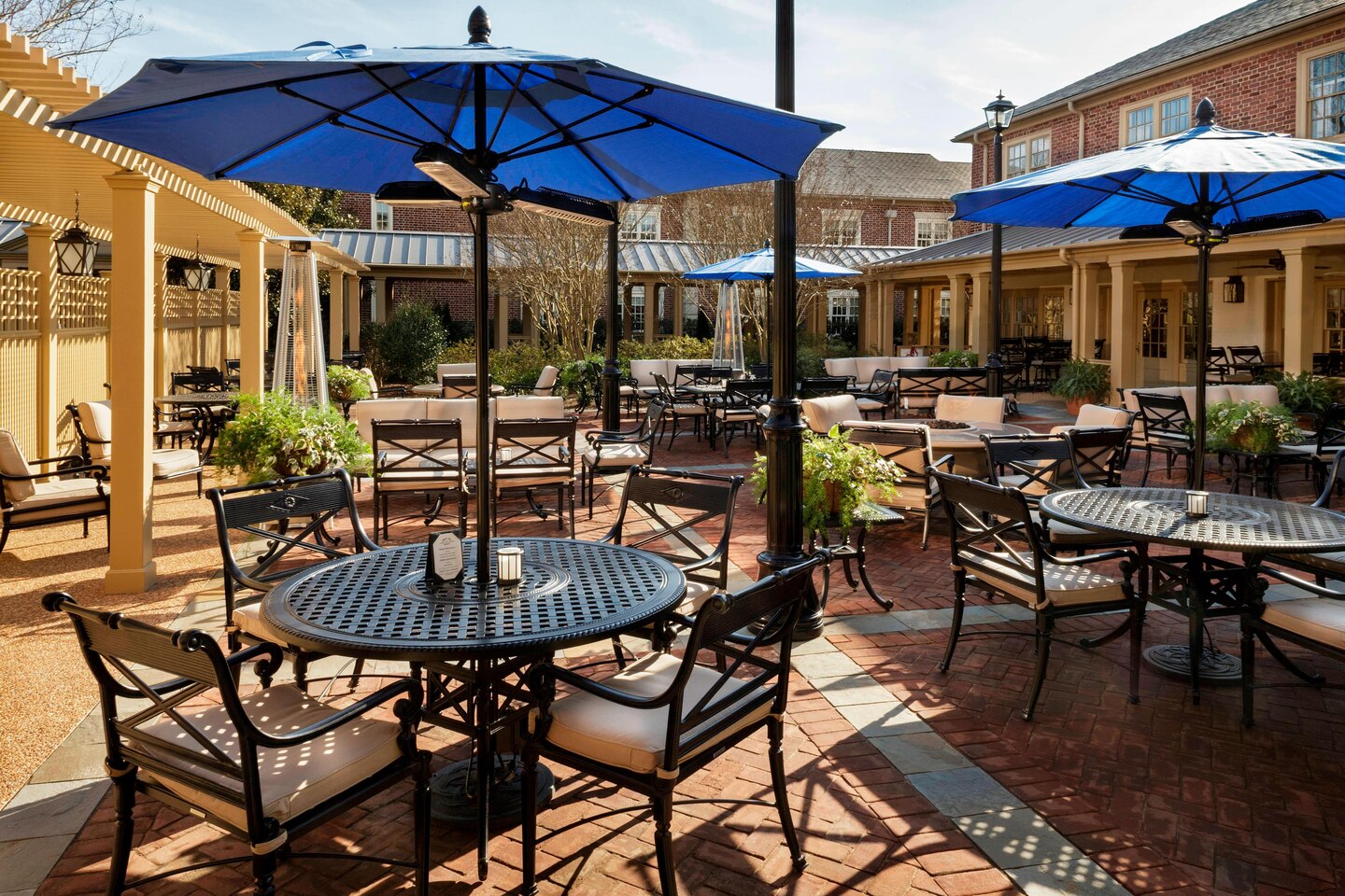 a patio area with tables and chairs