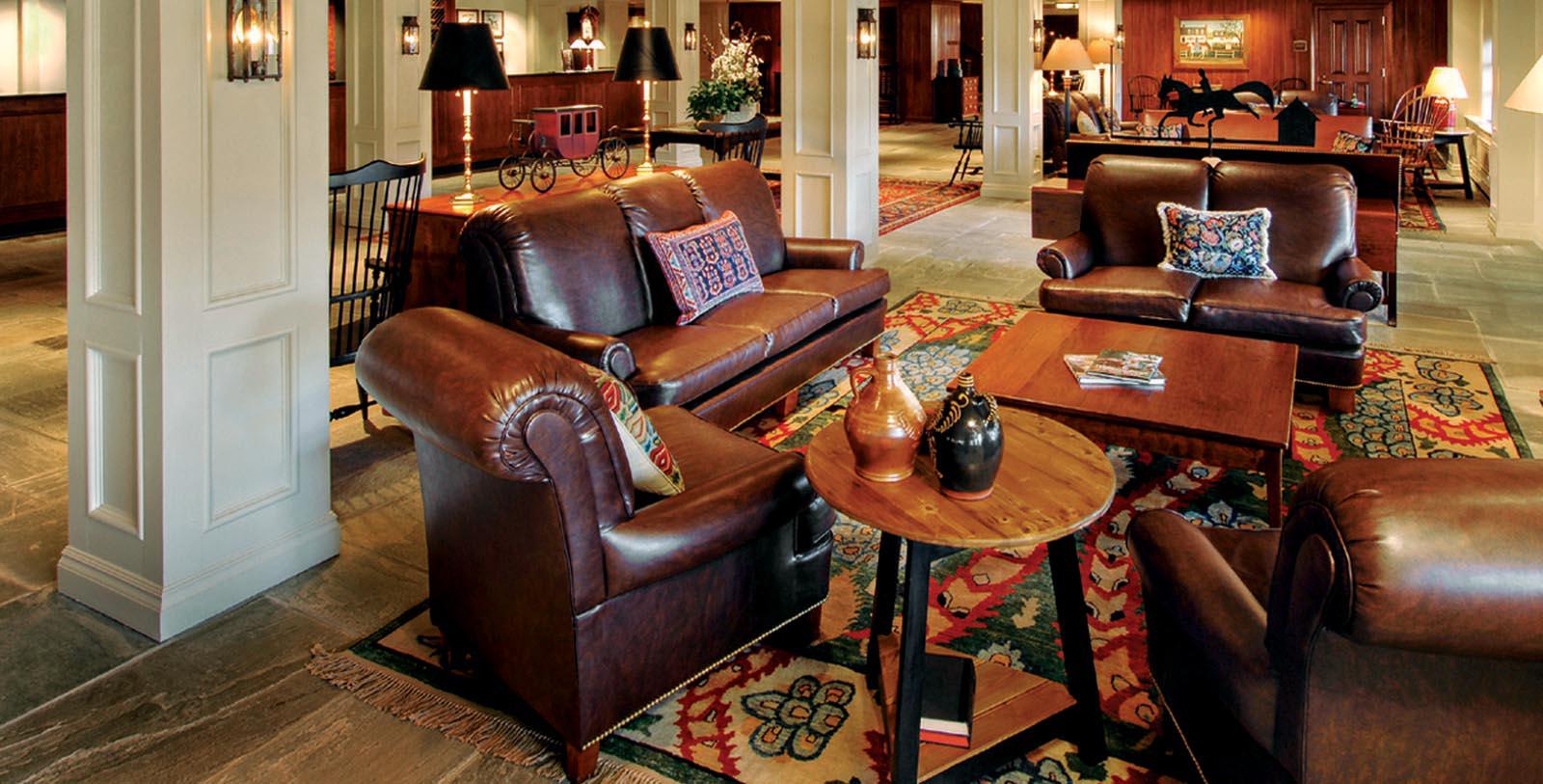 a room with leather couches and a table