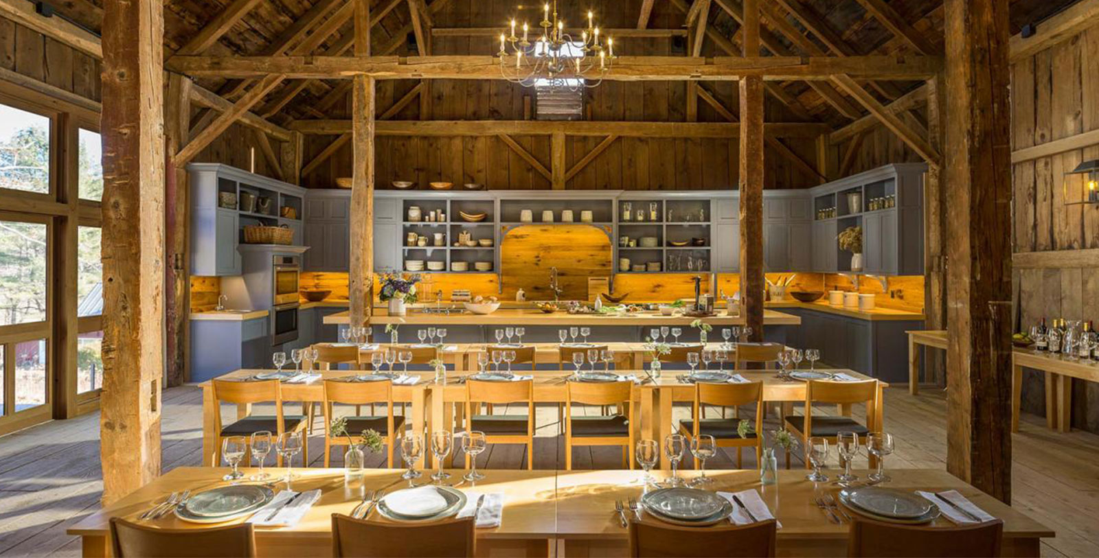 a room with wooden beams and tables and chairs