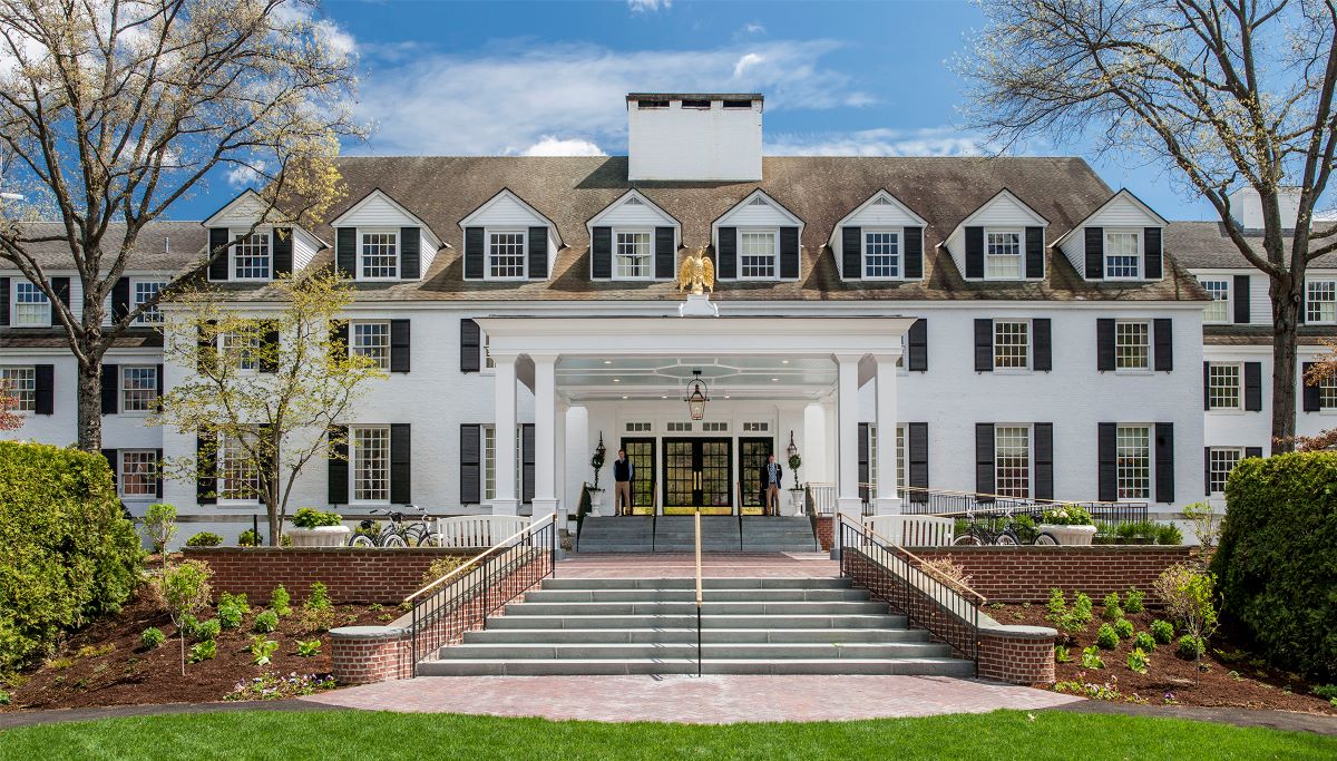 a large white building with a gold statue on the front