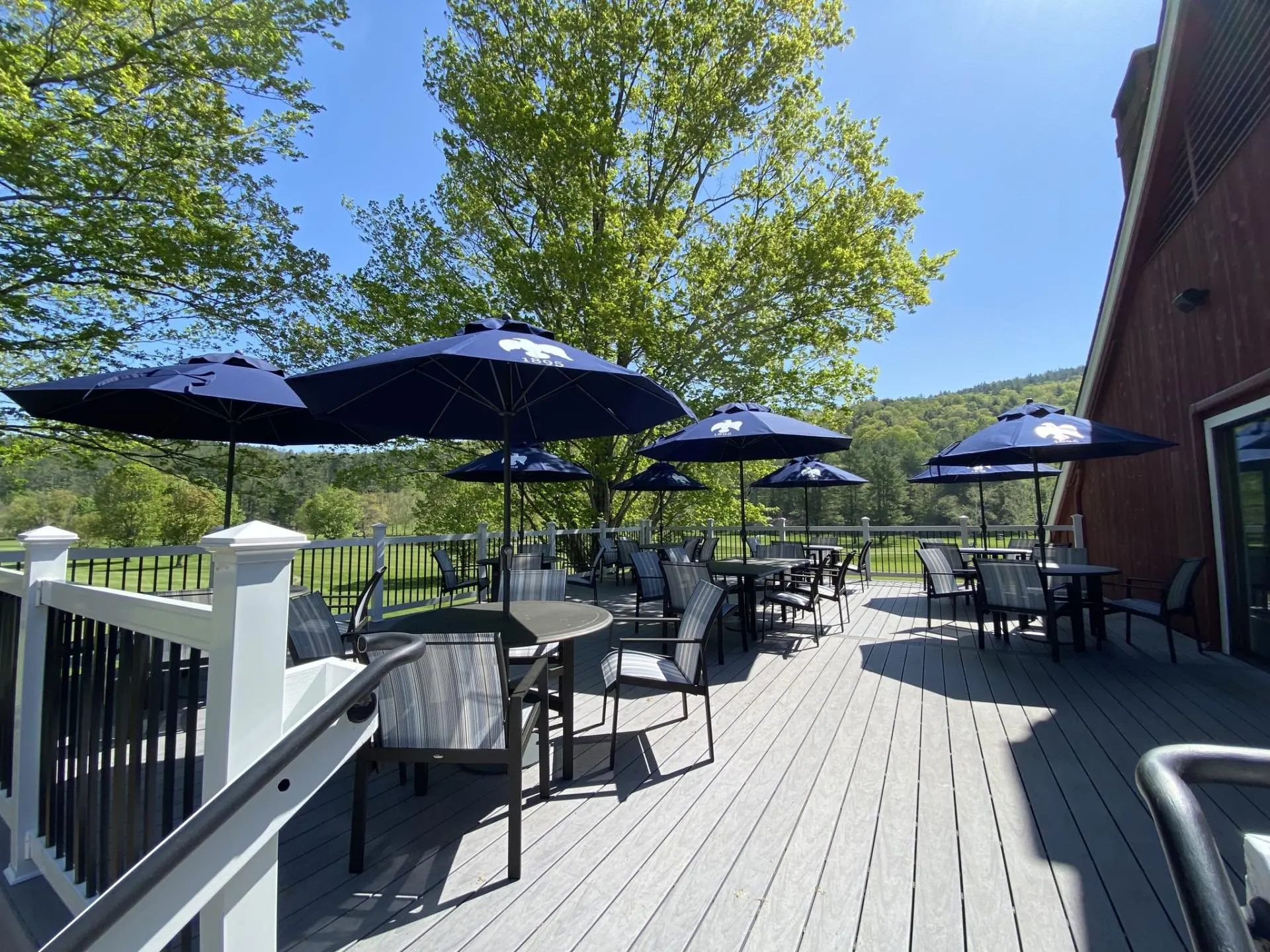 a patio with umbrellas and chairs