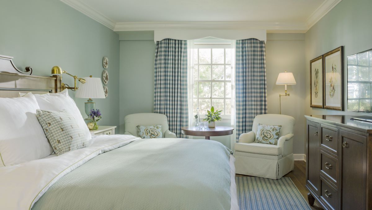 a bedroom with a bed and a lamp