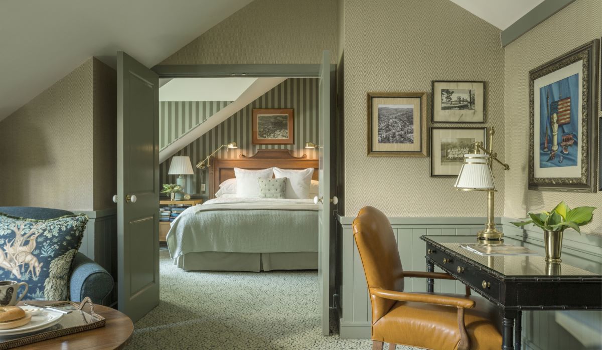 a bedroom with a desk and a bed