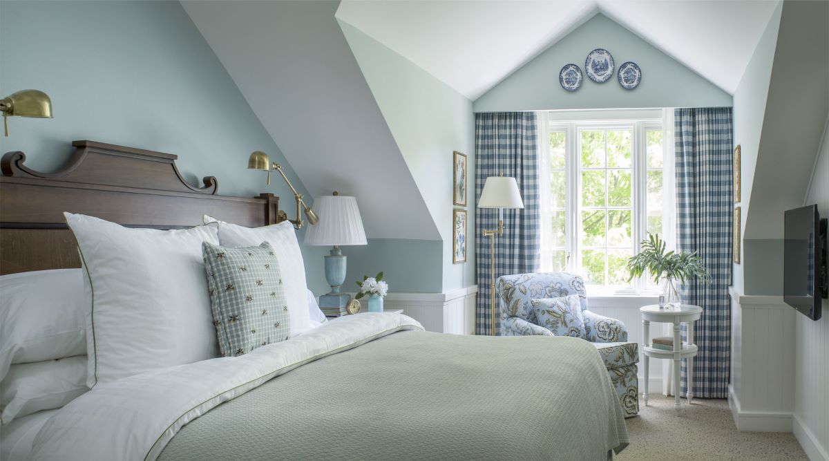 a bedroom with a bed and a chair