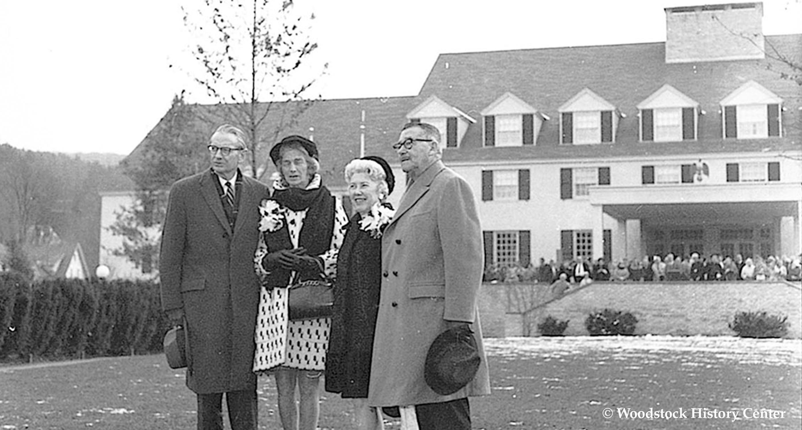 a group of people standing outside a house