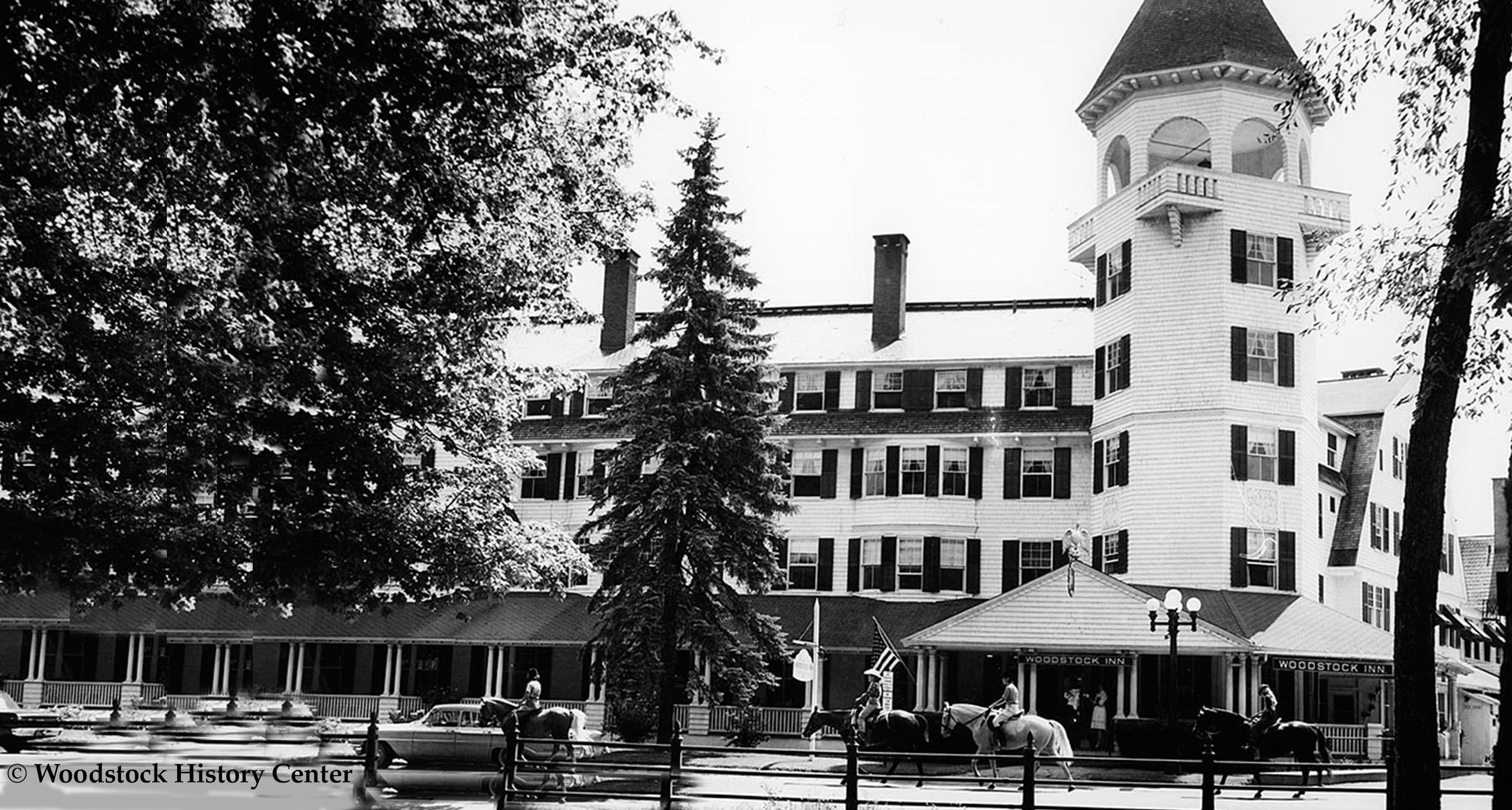 a horse riding in front of a large building