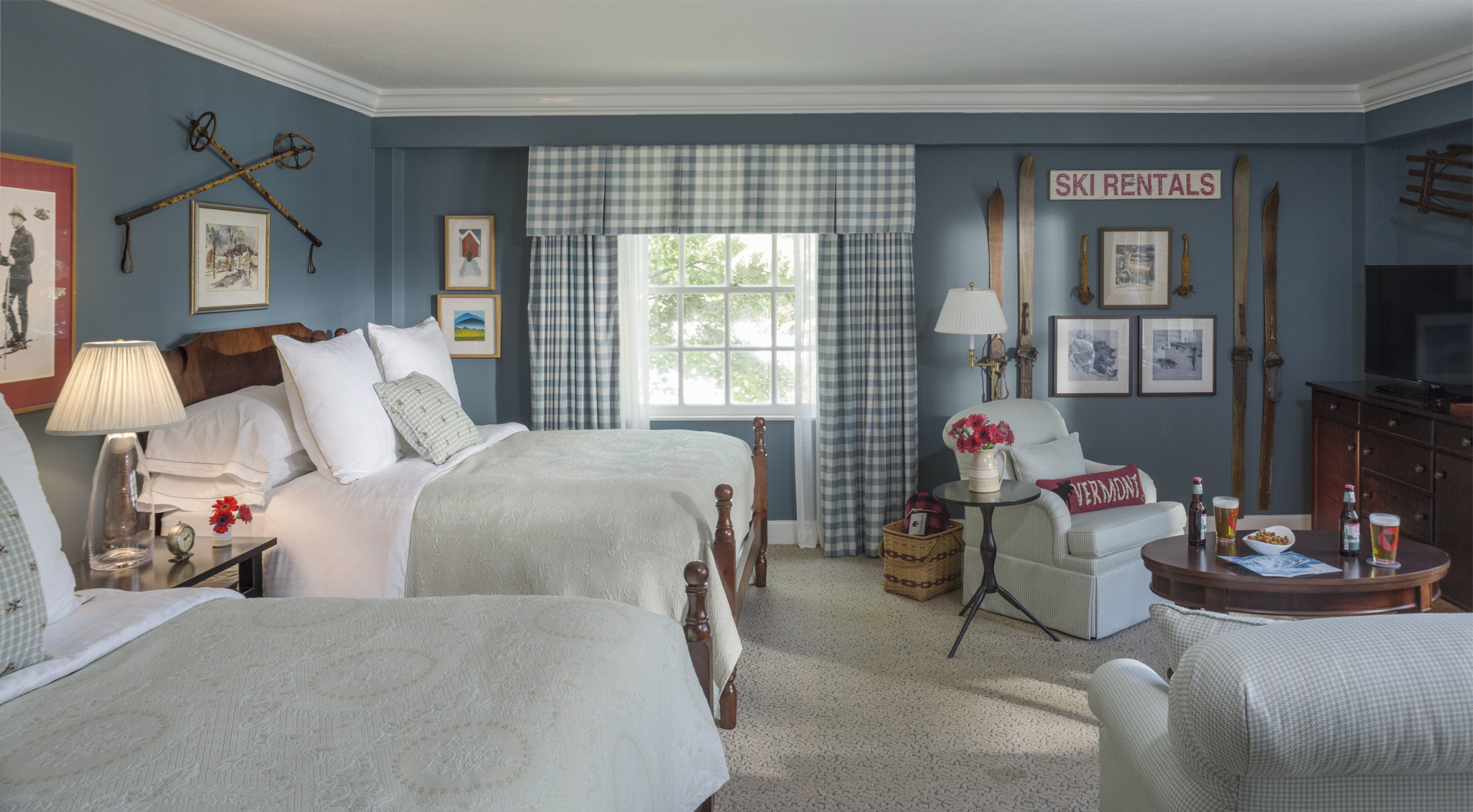 a bedroom with two beds and a chair