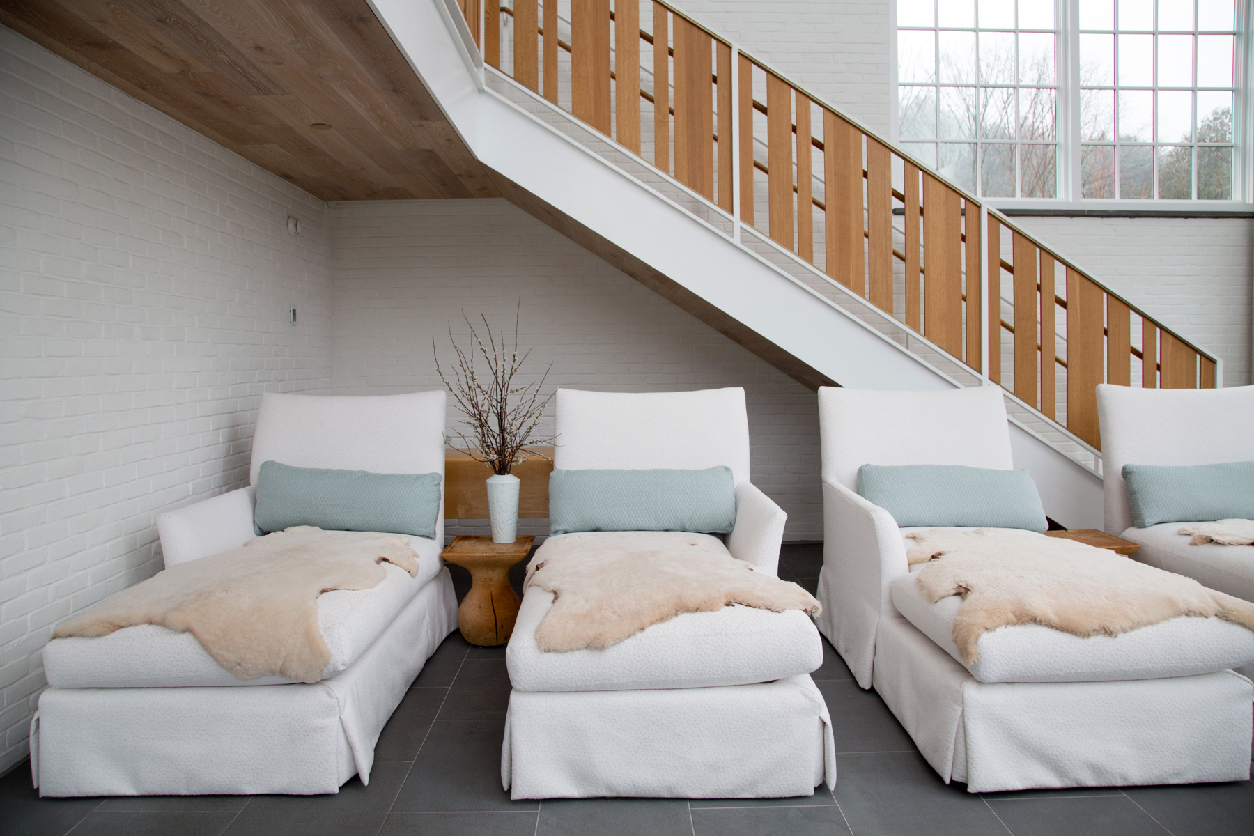 a group of chairs in a room with a staircase