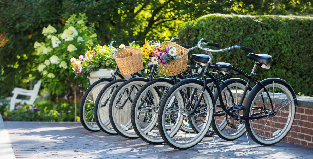 a group of bicycles with baskets of flowers