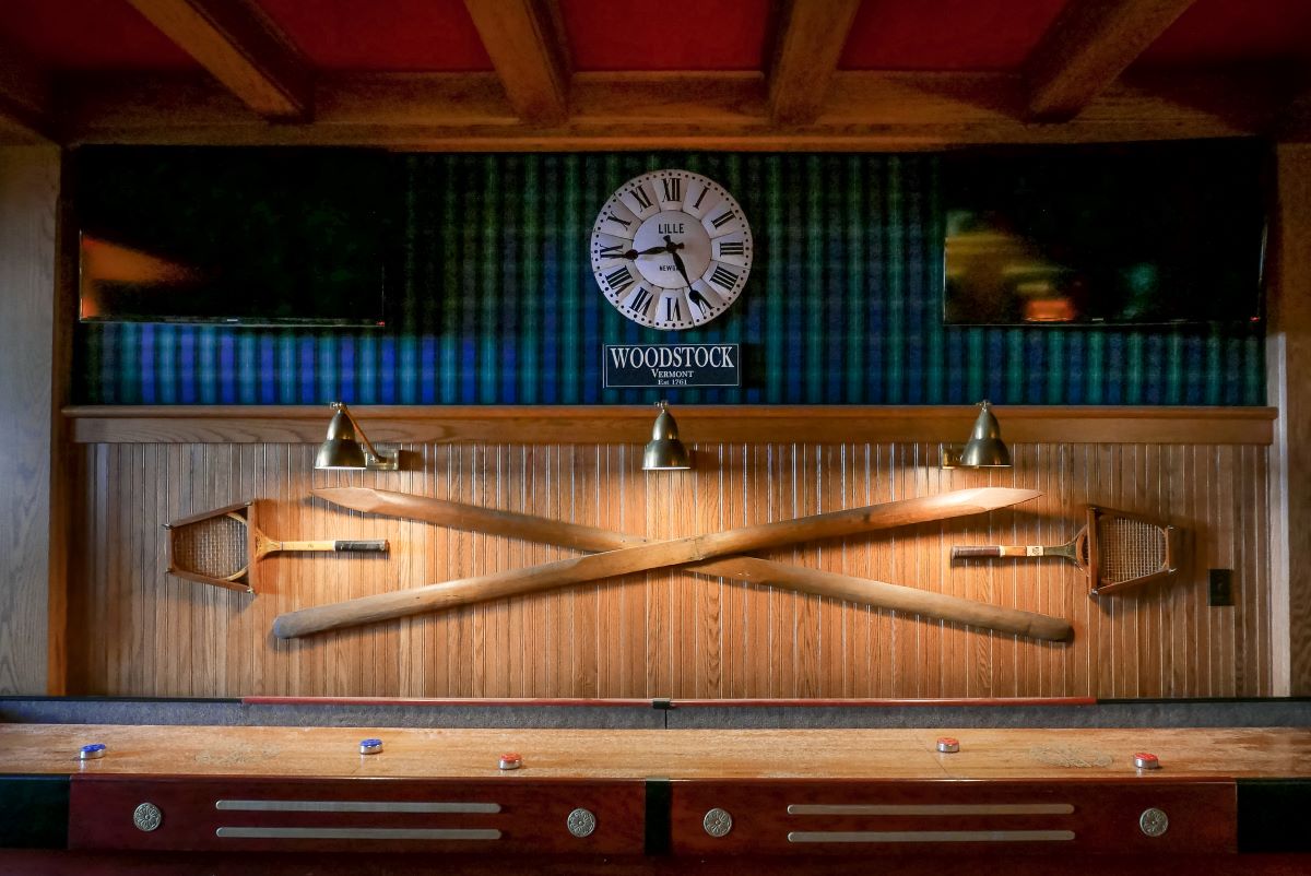a room with a pool table and rackets