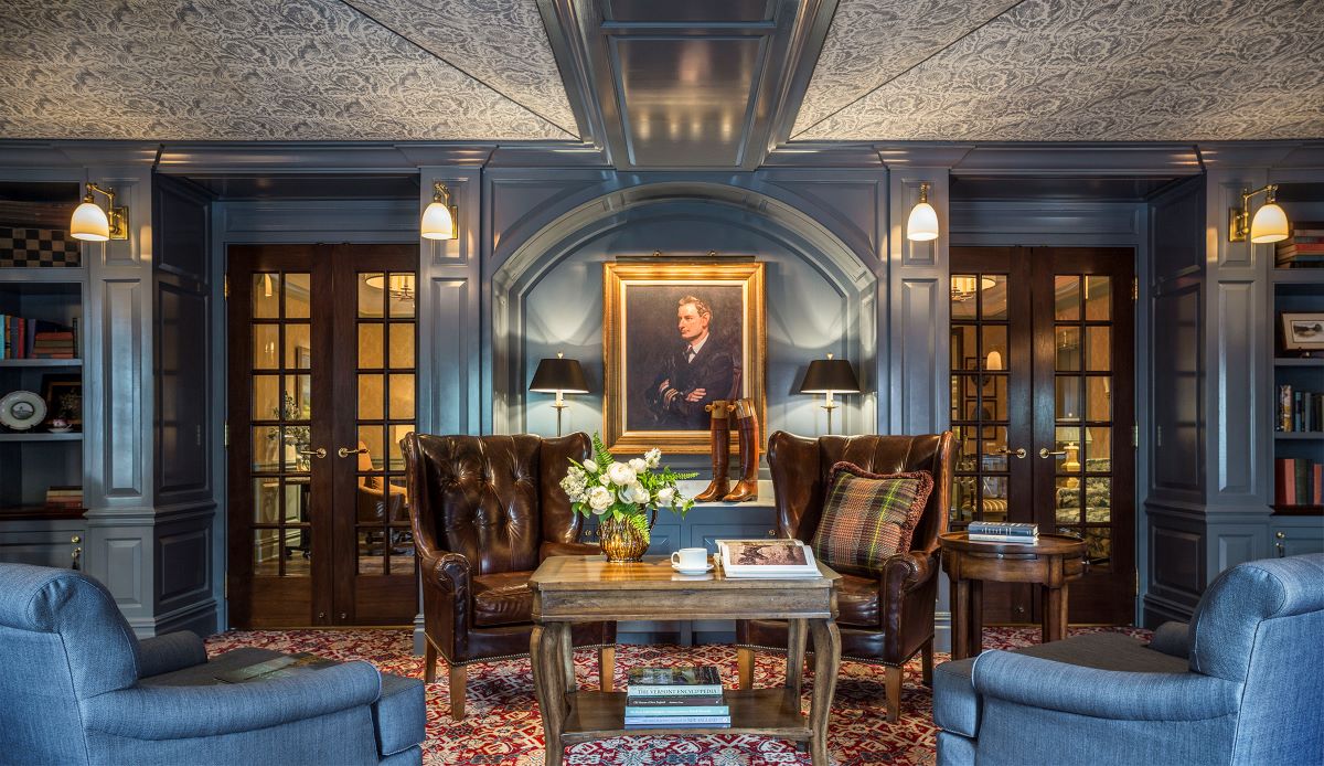 a room with a couch and chairs