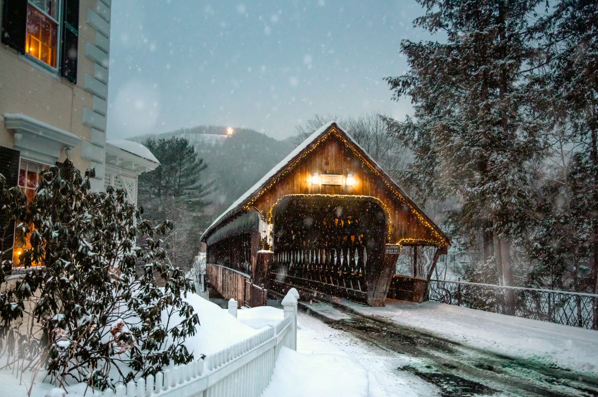 a covered bridge with lights on it