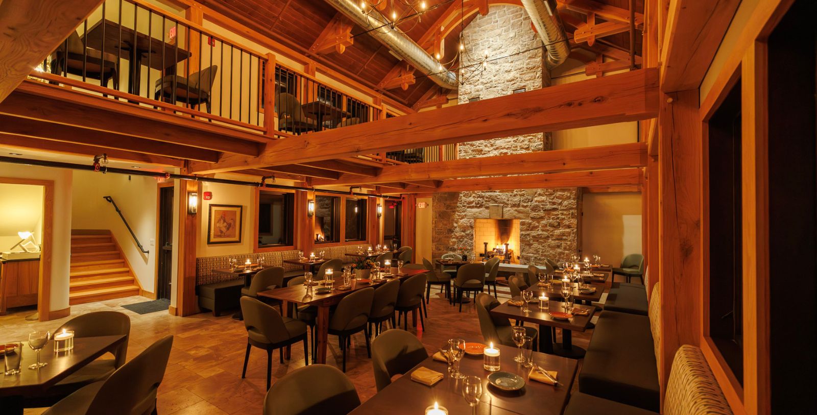a room with tables and chairs and a fireplace