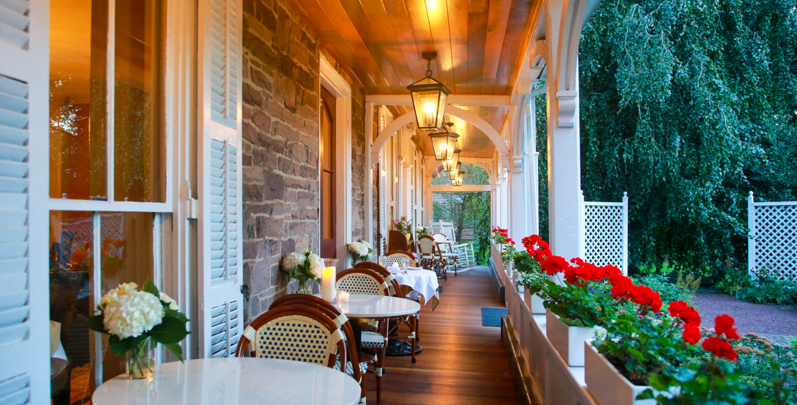 a porch with tables and chairs