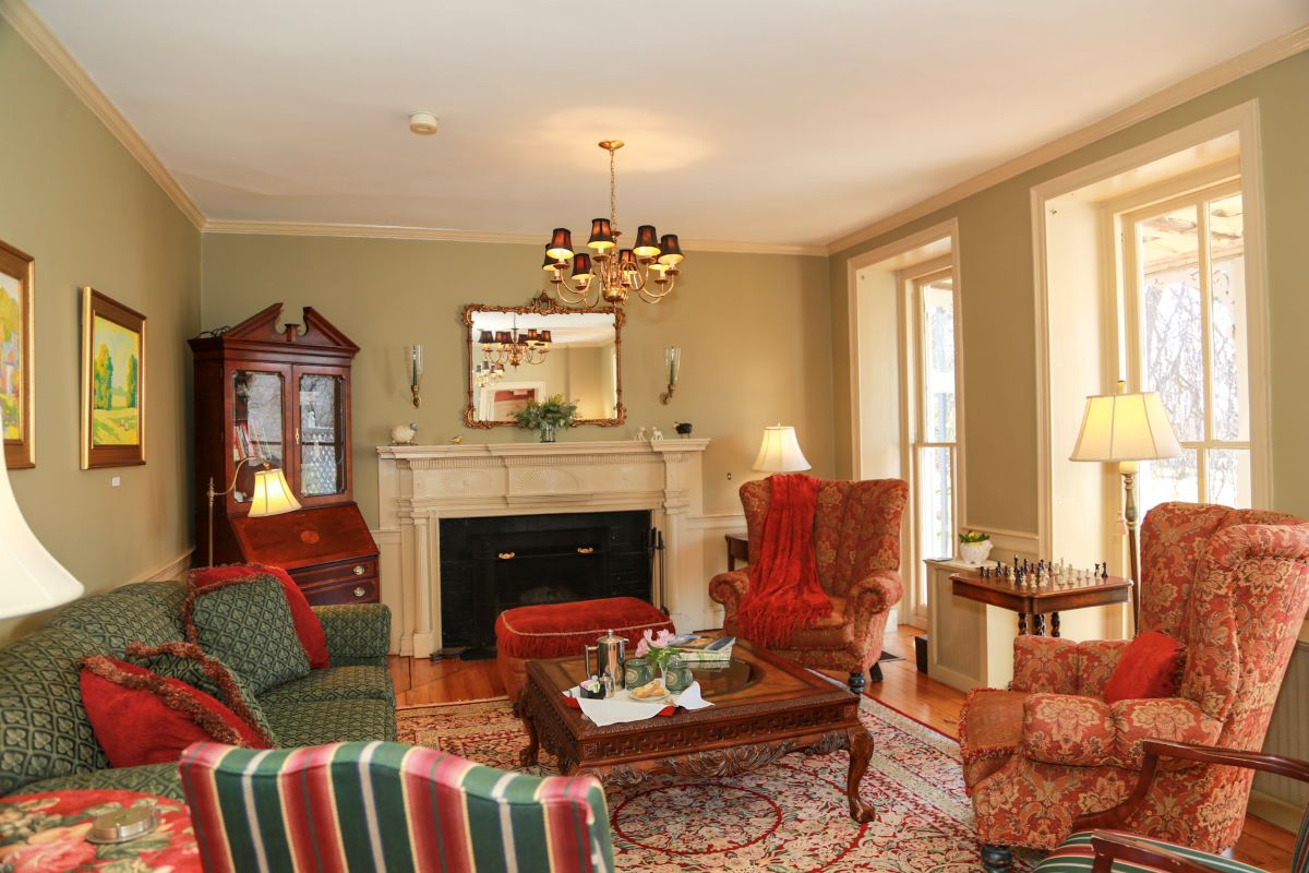 a living room with a fireplace and chairs